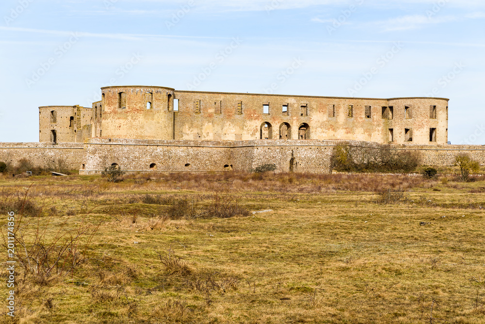 Historic castle ruin at Borgholm, Oland in Sweden. Here seen from a distance across the nearby landscape. A popular travel destination with historic values.