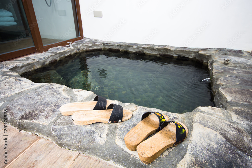 wooden slippers on hot spring water bath