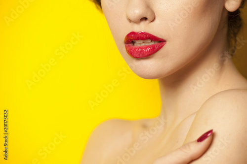 red glossy lipstick on yellow background