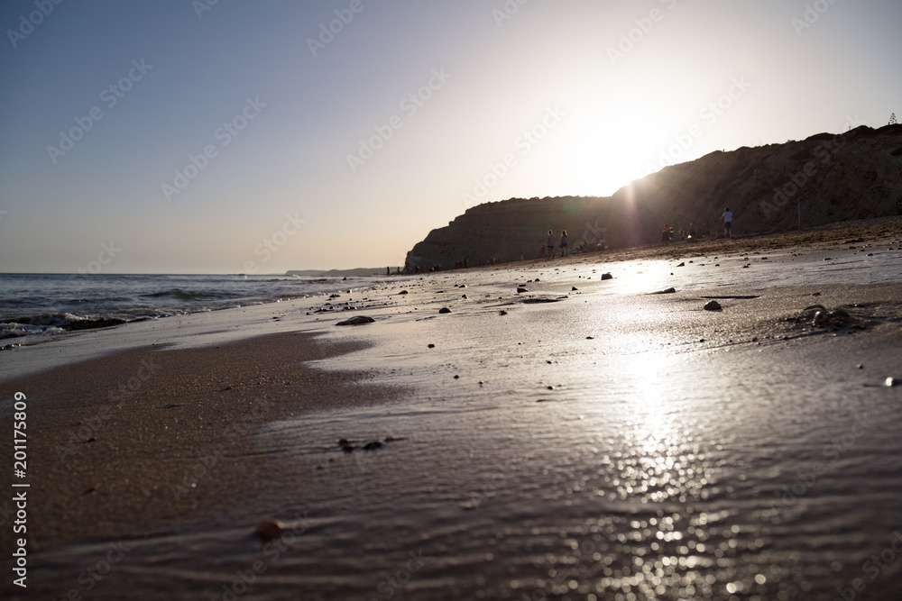 Beach and waves on sandy shore during sunset Beach and waves on sandy shore during sunset