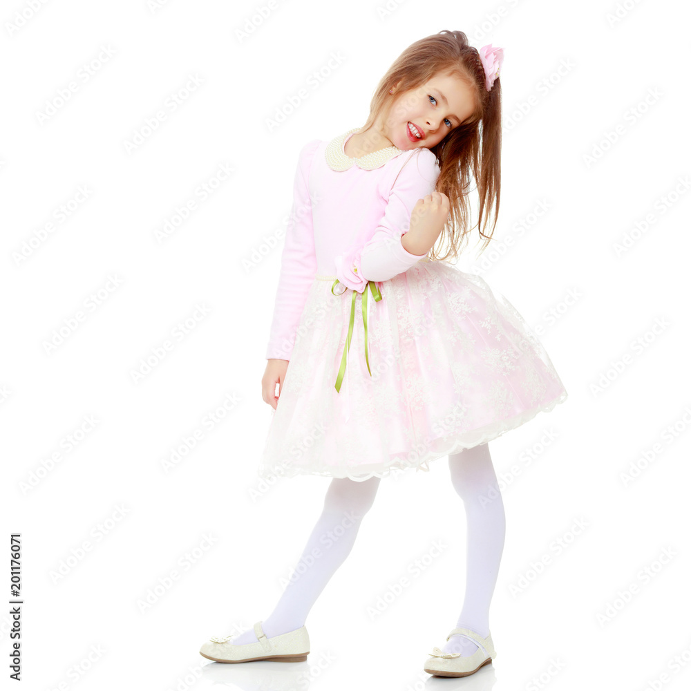 Elegant little girl in a pink dress.