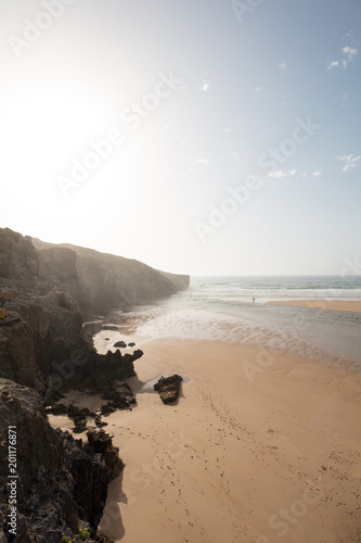 Cliffs meet beach and ocean photo