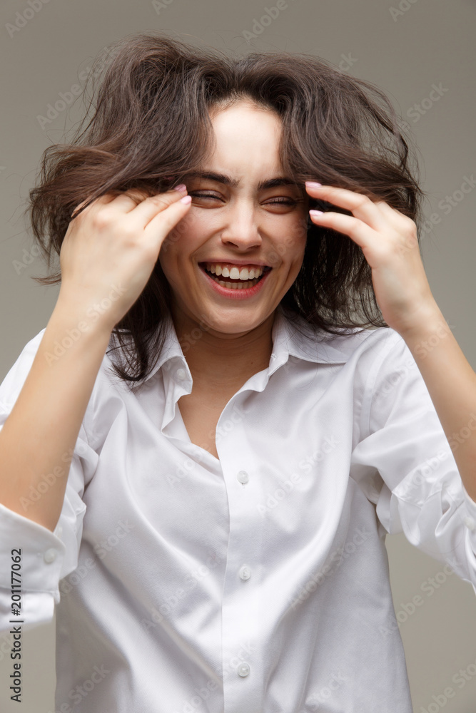 Beautiful girl in a white shirt shows emotions - smile, fun. Beautiful girl in a white shirt shows emotions - smile, fun.