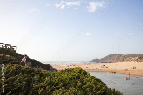 Man with backpack going to the beach in Portugal photo