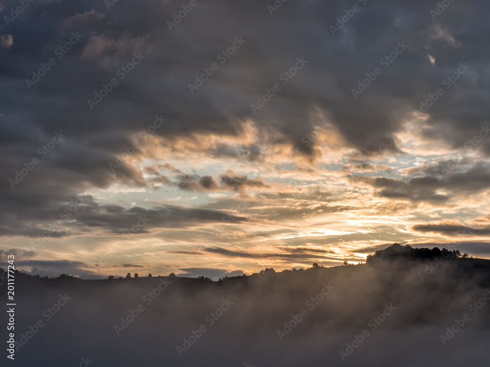 Beautiful sunrise light over the peaks of the mountains with trees silhouettes, Fundatura Ponorului, Hunedoara County, Romania Beautiful sunrise light over the peaks of the mountains with trees silhouettes, Fundatura Ponorului, Hunedoara County, Romania