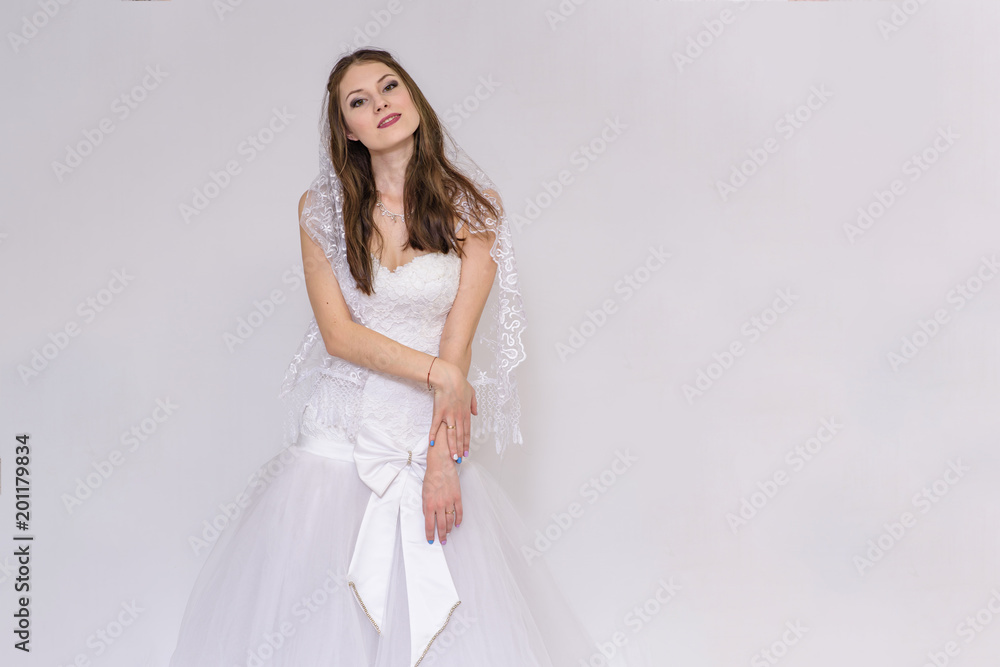 beautiful bride in white wedding dress in different poses on white backgrounds shows different emotions beautiful bride in white wedding dress in different poses on white backgrounds shows different emotions