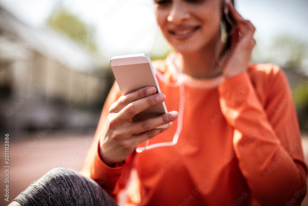 Close up image sport woman using smart phone. Close up image sport woman using smart phone.