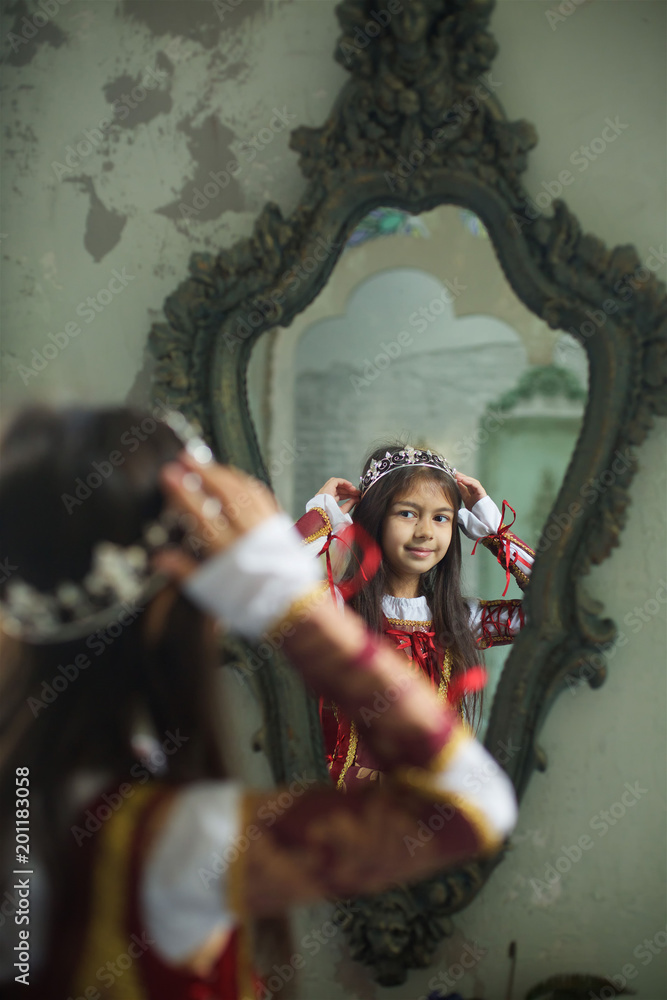 A beautiful cute little girl in a medieval historical costume