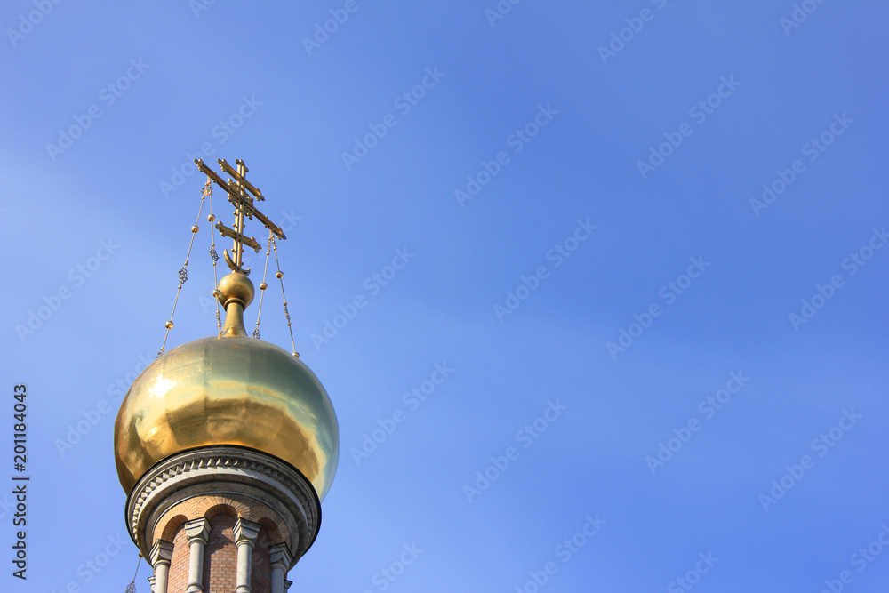  Golden Dome with Cross at Church.  Christian Orthodox Church Architecture Element Isolated on Empty Blue Sky Background. Religious Building Exterior of Old Historic Cathedral with Empty Copy Space.