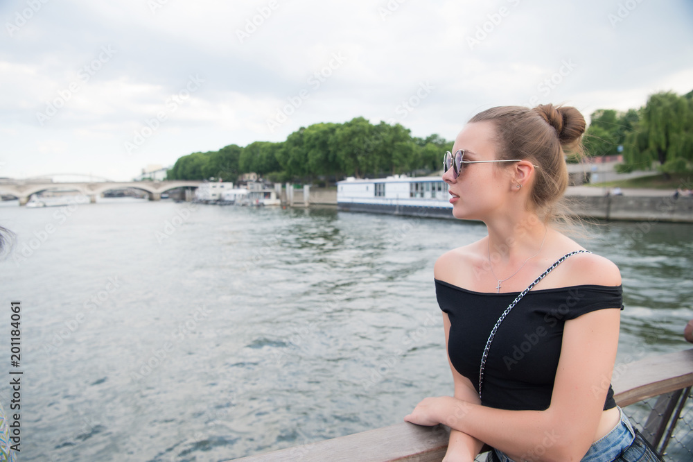 Woman look at seine river in paris, france. Sensual woman in sunglasses on bridge on summer day. Vacation and wanderlust concept