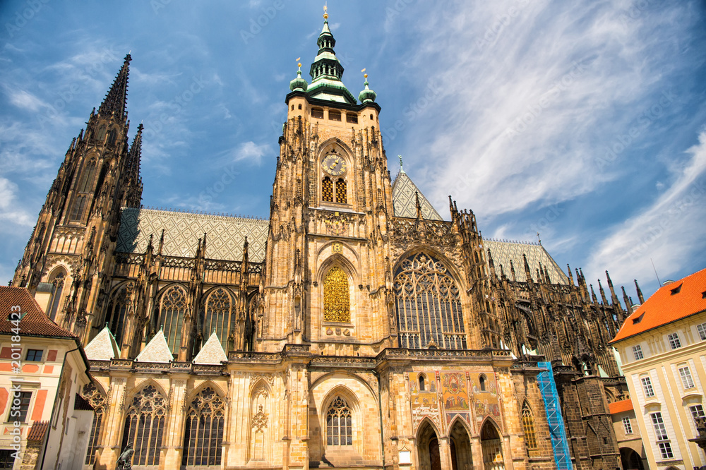 Church building in prague, czech republic. St.vitus cathedral on cloudy blue sky. Monument of gothic architecture and design. Vacation and wanderlust concept