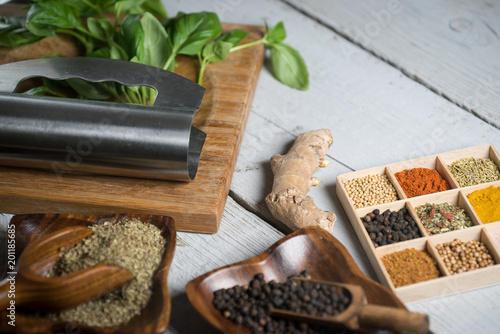 Variety of dry and fresh spices and herbs on table.