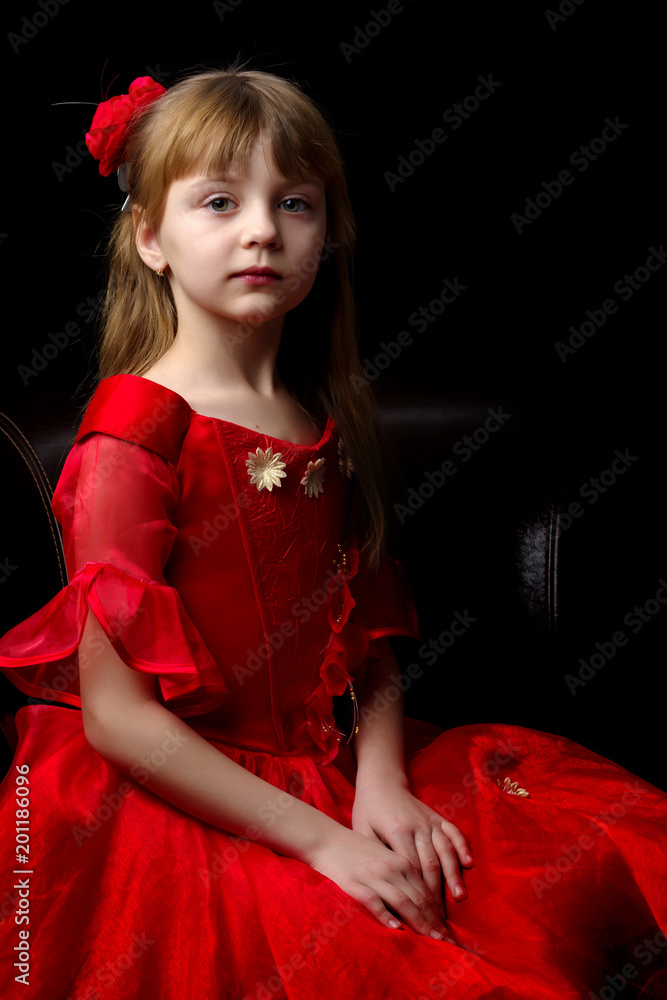 Fototapeta premium Little girl on a black background