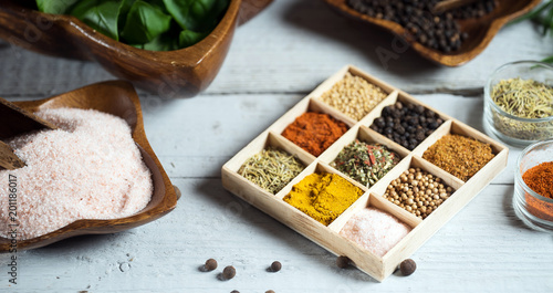 Variety of dry and fresh spices and herbs on table.