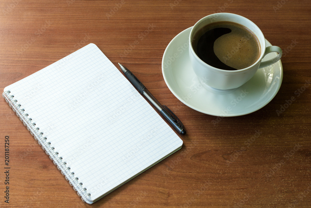 school notebook with pen and coffee Cup on table school notebook with pen and coffee Cup on table