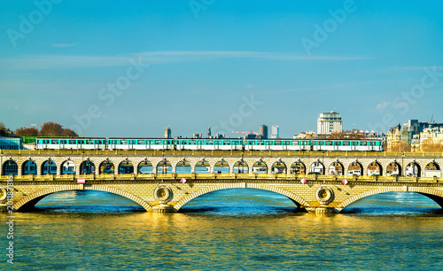 Canvas Print Metro train on the Pont de Bercy, a bridge over the Seine in Paris, France