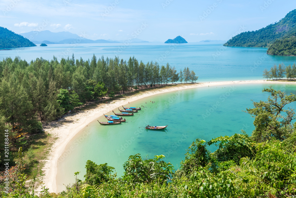 White sand beach and Long-tail boat at Kham-Tok Island (koh-kam-tok), The beautiful sea Ranong Province, Thailand.
