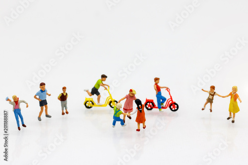 Miniature people children playing on Bicycle, happy family day concept.
