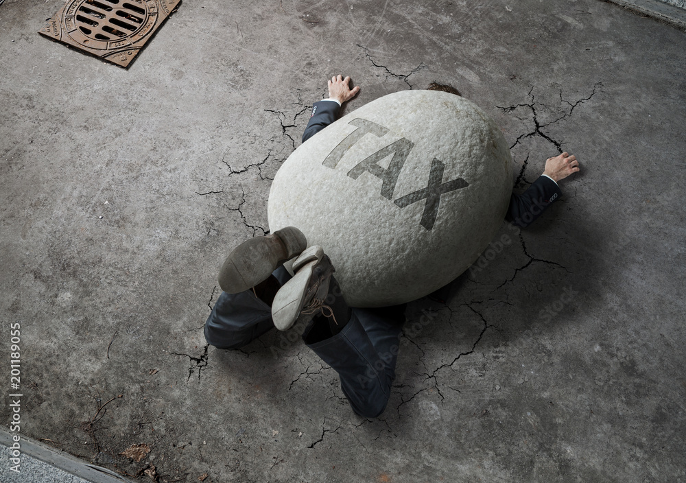 Tax concept, high angle view of businessman crushed by the huge stone on the street - obrazy, fototapety, plakaty 