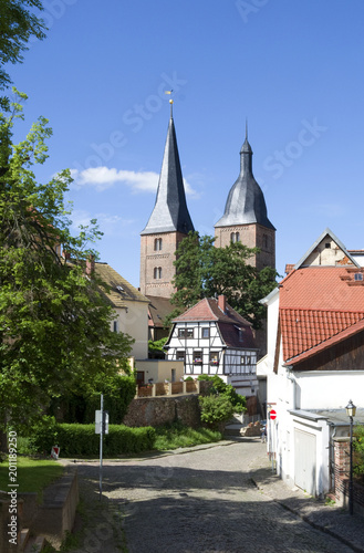 Altenburg / Germany: Historic cobblestone road with an old timbered house in front of the so called Red Spires of the former collegiate church of the Virgin Mary