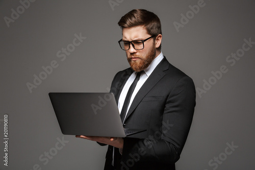 Portrait of a serious young businessman dressed in suit