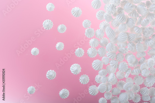 French vanilla meringue cookies on pink background with copy space.