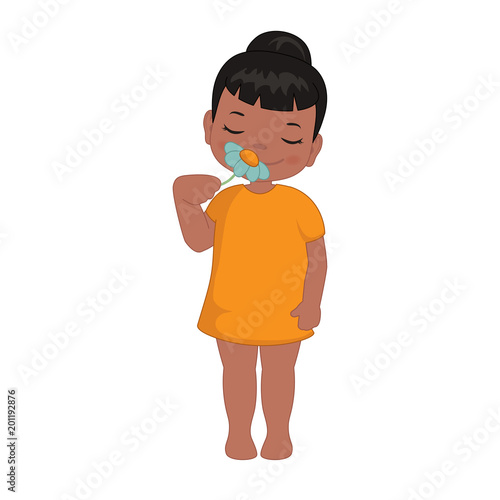 Little girl sniffs a flower