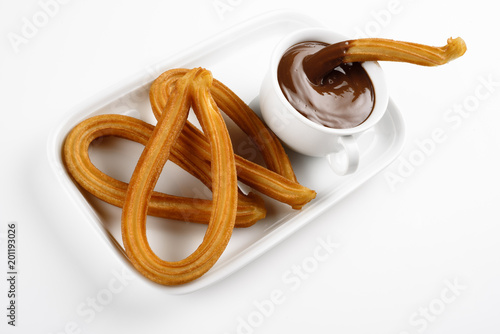churros with chocolate on a white tray