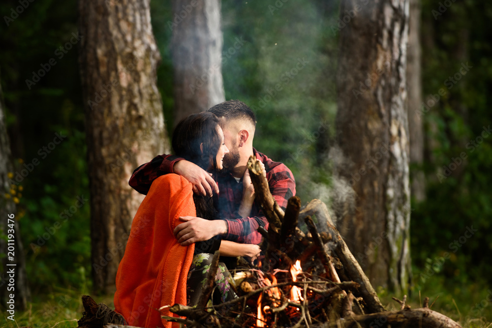 Man with woman hugs and kissing near bonfire. Man with woman hugs and kissing near bonfire.
