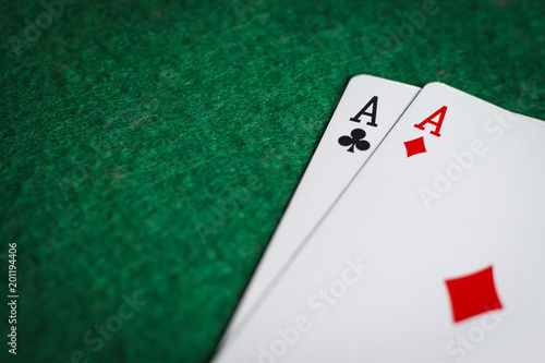 A pair of aces on a green poker table photo