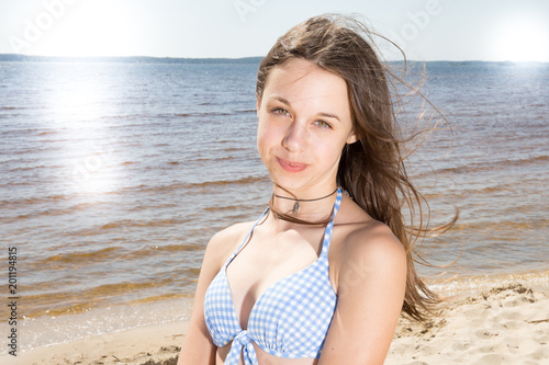 Woman on the beach enjoying the summer girl in swimsuit