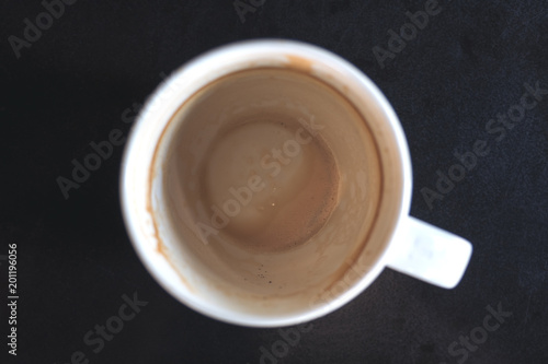 Top view image of finished cup of coffee on table in cafe