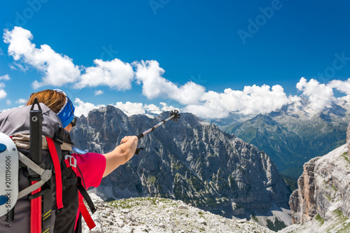 Female climber pointing towards next challenge.