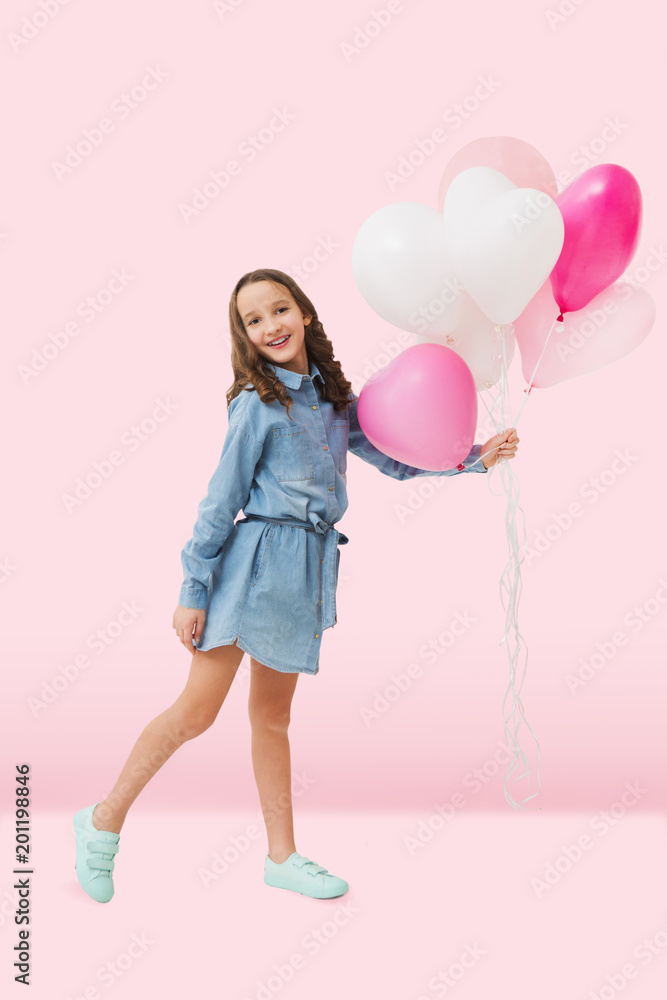 Happy cute little girl with pink balloons on a pink background. mother's day. Children's funny birthday party. Happy cute little girl with pink balloons on a pink background. mother's day. Children's funny birthday party.