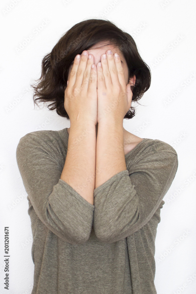 girl covering her face with her hands girl covering her face with her hands