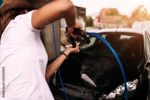 Woman washing the car.