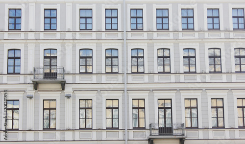 Historic Building Facade Architecture Classic Old House Close Up View in Saint Petersburg, Russia. Classic European City Apartment Building Exterior, Front View with Windows in Row and Small Balcony.