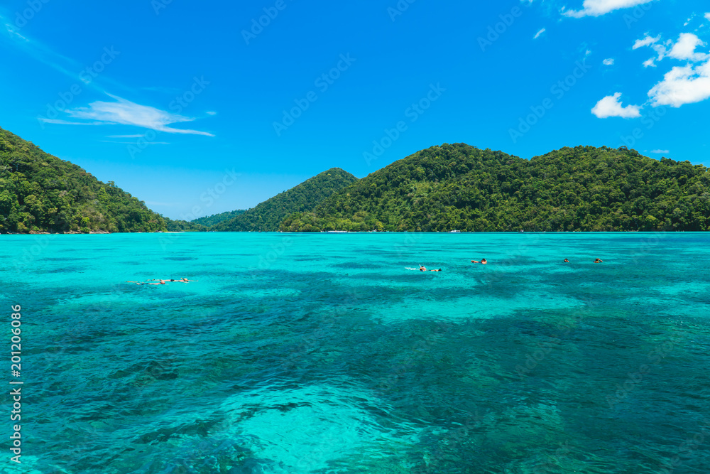 Tourists snorkeling at beautiful blue water at Surin island located at Phang Nga, Thailand