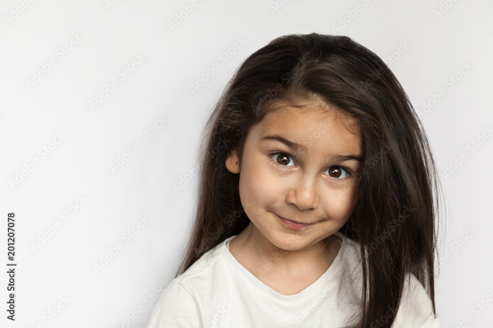 Portrait of happy smiling brunette child girl with long hear isolated on white background. Place for text. Portrait of happy smiling brunette child girl with long hear isolated on white background. Place for text.