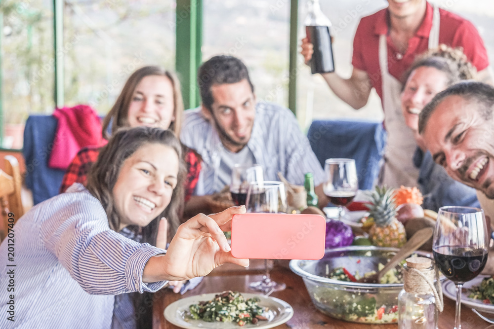 Happy friends taking selfie during vegetarian dinner at home Happy friends taking selfie during vegetarian dinner at home