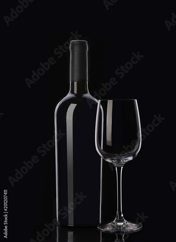 Bottle of red wine and glass on black background