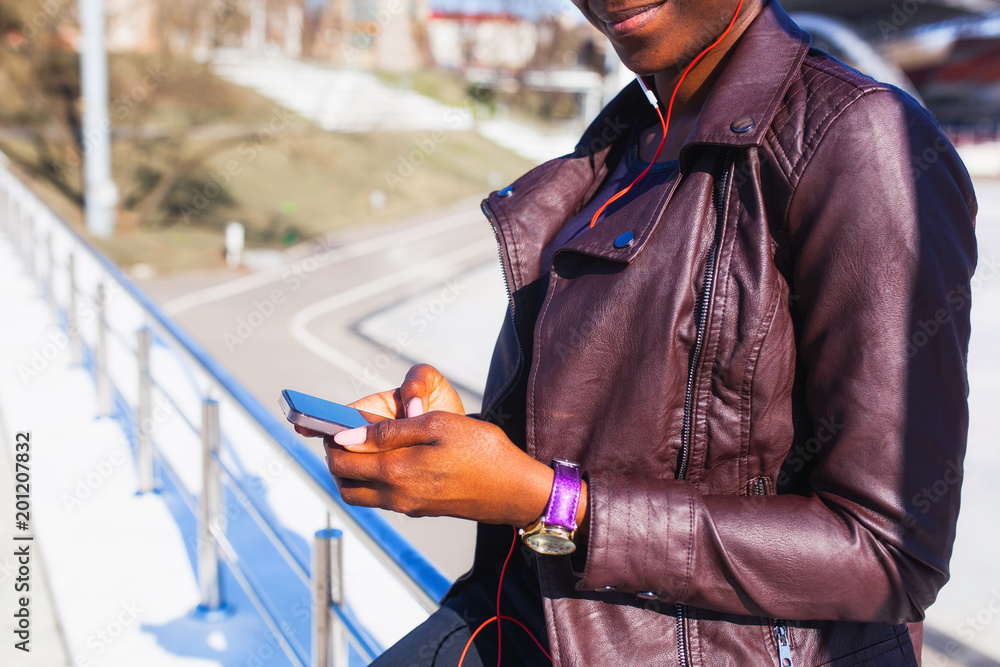 Fototapeta premium spring music. attractive young modern woman listening to music with cellphone