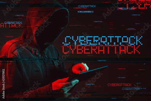 Cyberattack  concept with faceless hooded male person photo