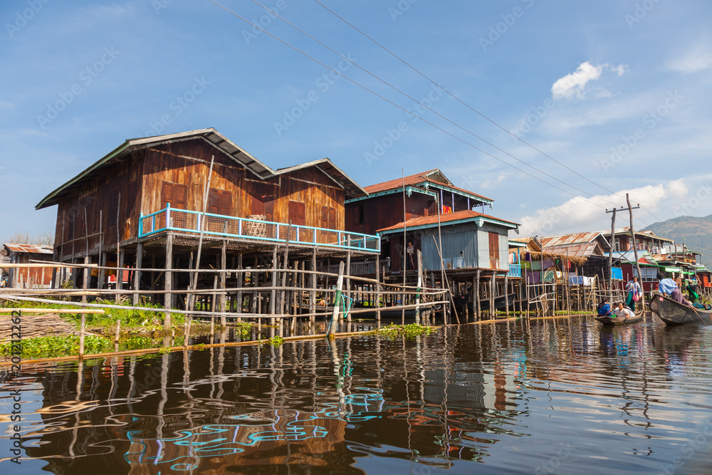 Inle Lake. Myanmar-December 21, 2015. Stilted houses of Mine Thauk village with local people at every day life on December 21, 2015 at Inle Lake in Myanmar. Inle Lake. Myanmar-December 21, 2015. Stilted houses of Mine Thauk village with local people at every day life on December 21, 2015 at Inle Lake in Myanmar.