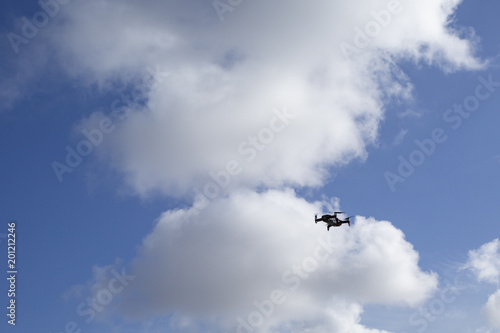 Flying drone, isolated against blue sky