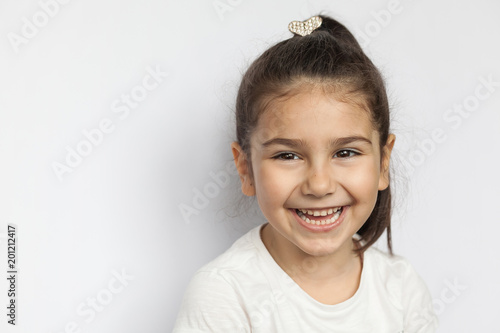 Portrait of happy cute brunette child  girl on white background