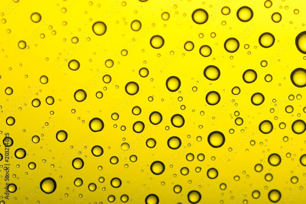 Drops of water on a color background. Yellow tone Drops of water on a color background. Yellow tone