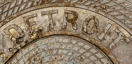 Detroit Michigan Background. Rusty manhole cover with the word Detroit engraved on it.