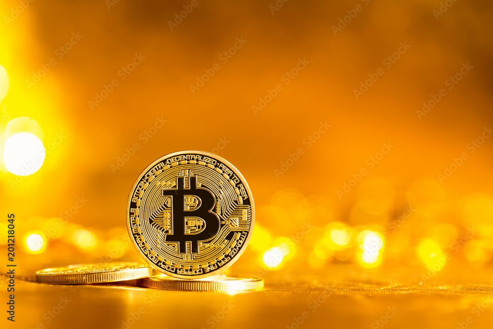 Bitcoin cryptocurrency coin on a bright gold background Bitcoin cryptocurrency coin on a bright gold background