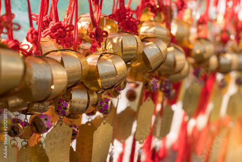 Group of golden bell with greeting word or lucky word at Wong Tai Sin Temple traveler or Hong Kong people wish and hang on tope for pray.